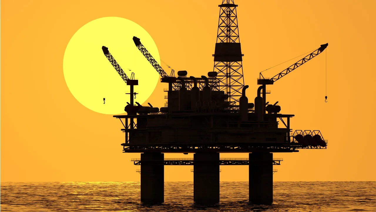 Offshore oil and gas platform at sunset