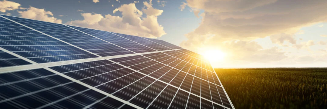Solar energy panels under an evening sky